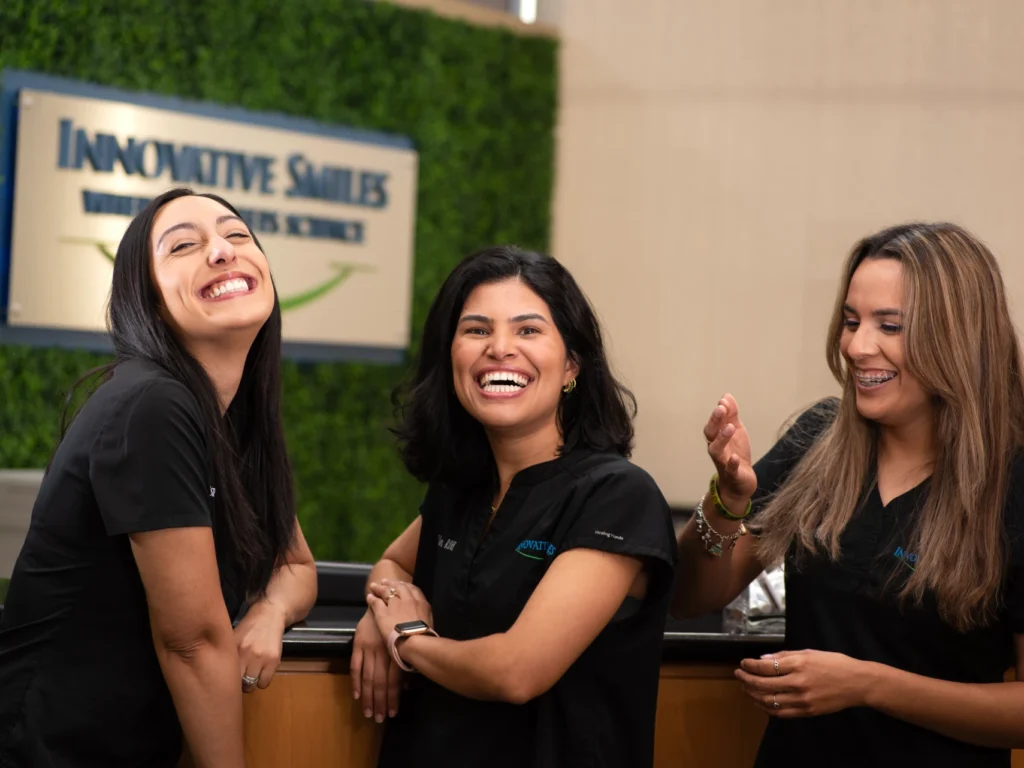 friendly dental team at Innovative Smiles smiling and laughing together